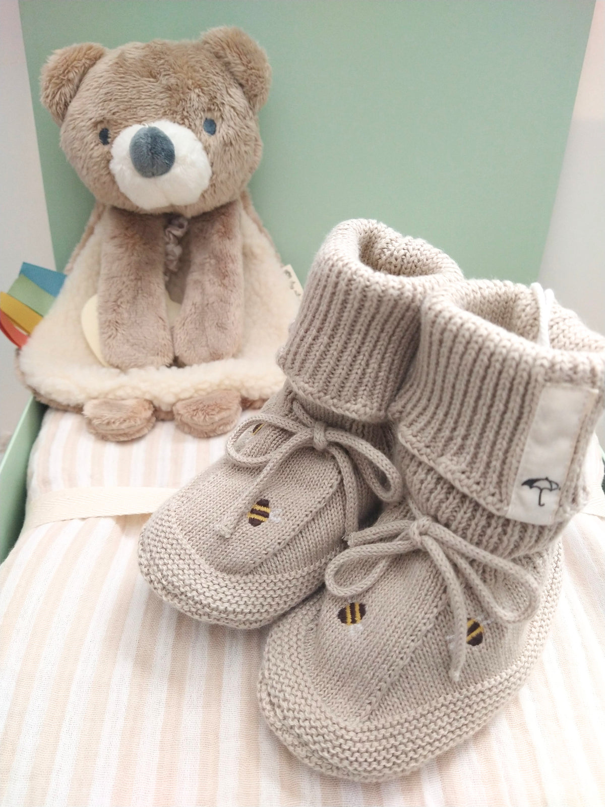 Petite Evelina Beige Stripes baby blanket with Theo Bear Lovey and Saga Copenhagen Honey Bee booties.