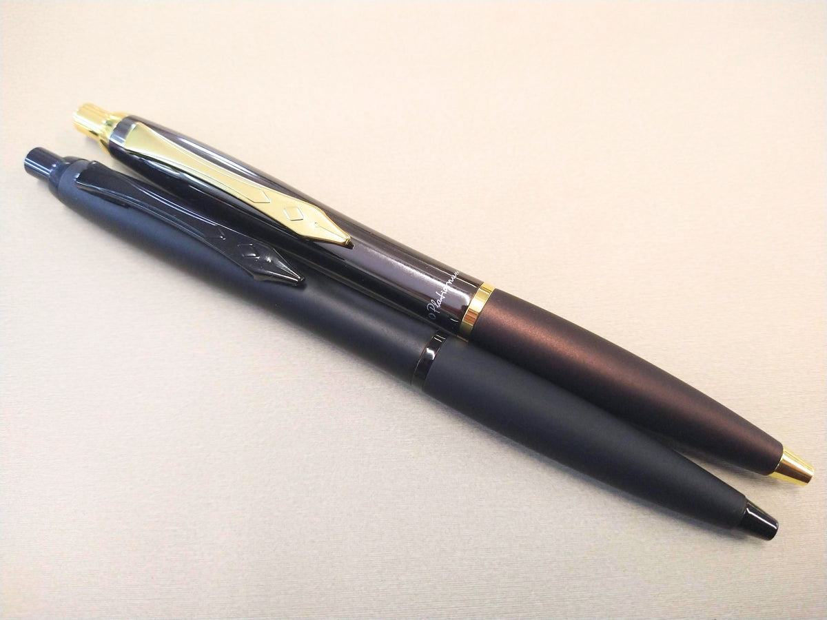 Matte black and gunmetal Platignum No. 9 ballpoint pens with metal clips.