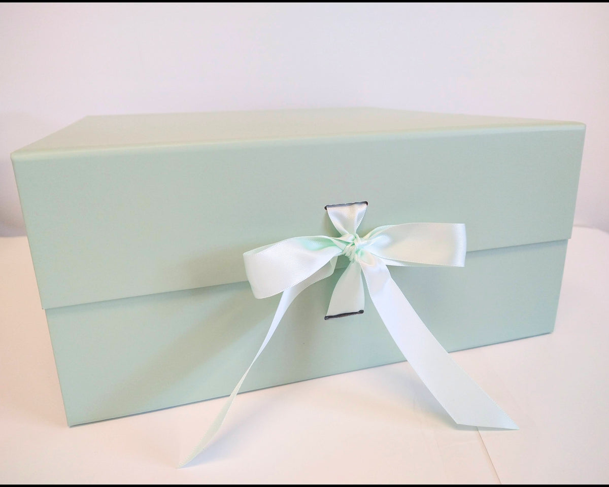 Sage green gift box with matching ribbon.