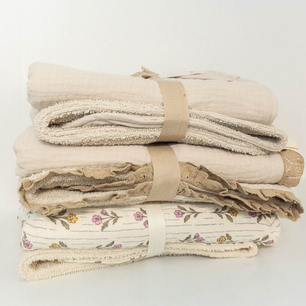 Assortment of Petite Evelina hooded baby towels in neutral and floral patterns