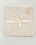 Petite Evelina beige striped muslin baby swaddle folded and tied with a cream ribbon