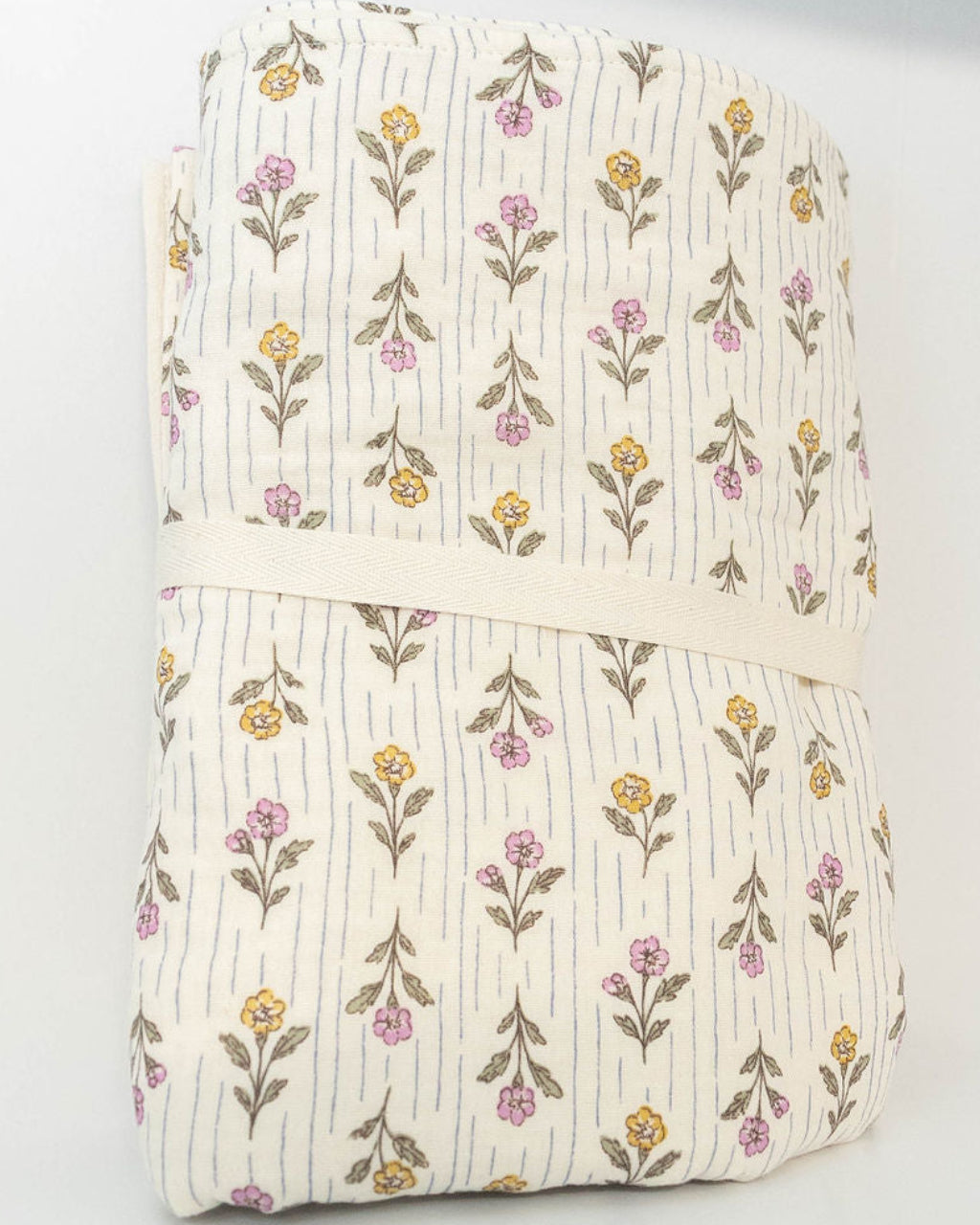 Back view of Petite Evelina Meadow Whisper muslin baby blanket with delicate floral print