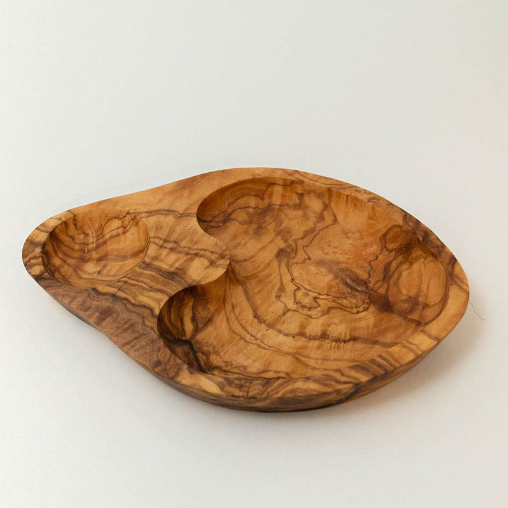 Handcrafted three-section olive wood serving dish showing natural grain and divided compartments