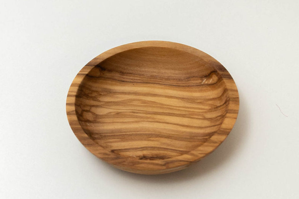 Handcrafted round olive wood dipping dish with natural wood grain