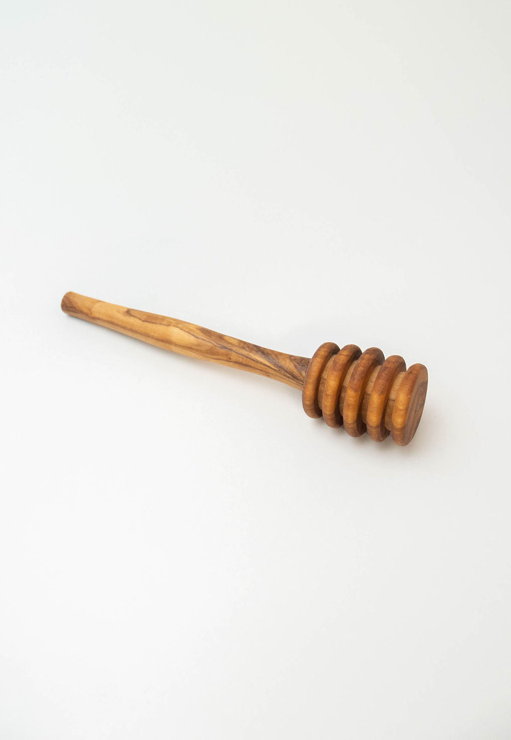 Handcrafted olive wood honey dipper with natural wood grain