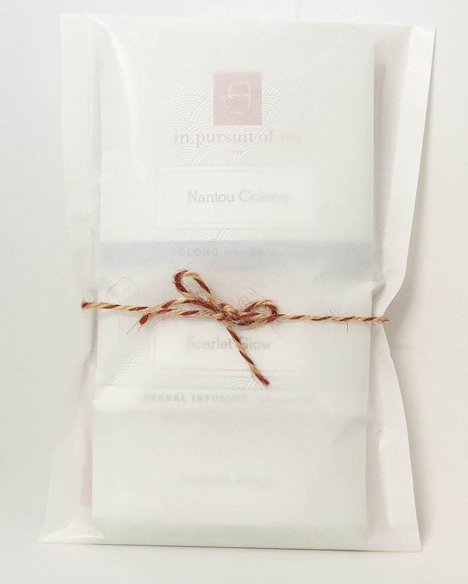 Seven In Pursuit of Tea sachets wrapped in glassine and tied with twine