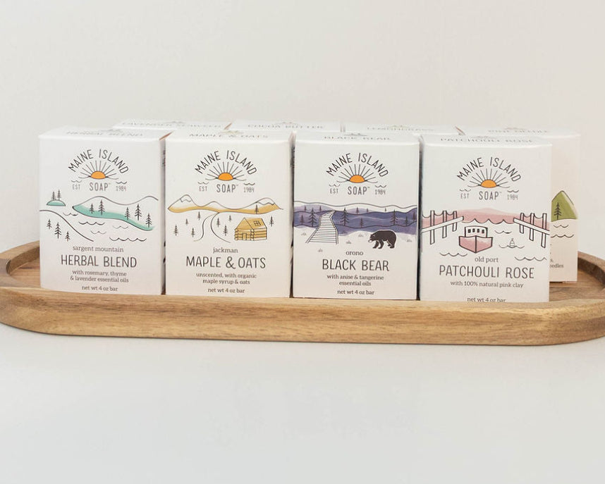 Assortment of Maine Island Soap bars displayed on a wooden tray