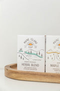 Maine Island Soap Herbal Blend bar displayed with other scents on a wooden tray