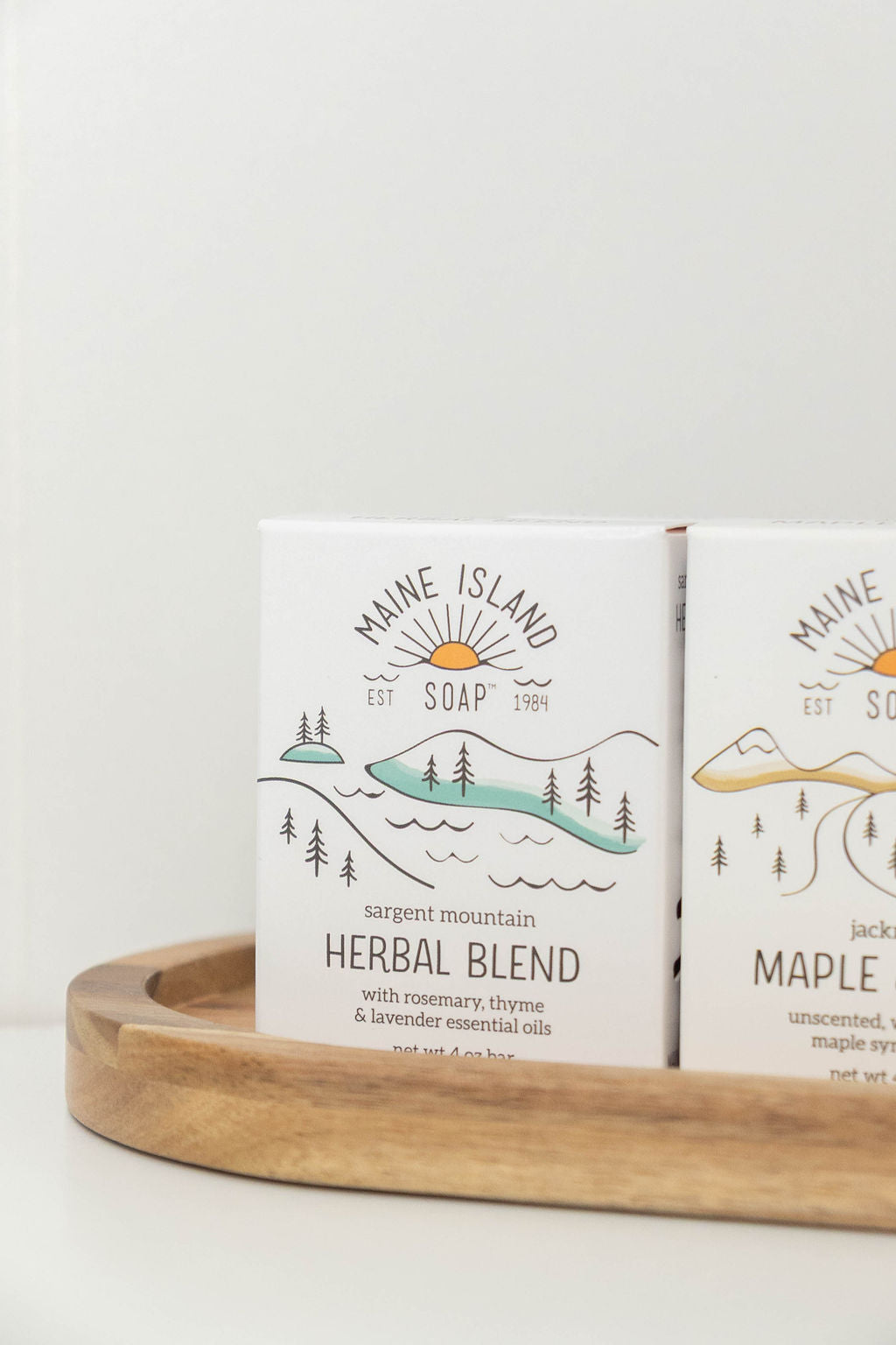 Maine Island Soap Herbal Blend bar displayed with other scents on a wooden tray