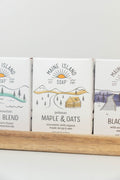 Maine Island Soap Maple & Oats bar displayed with other scents on a wooden tray