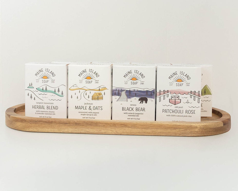 Assortment of Maine Island Soap bars displayed on a wooden tray