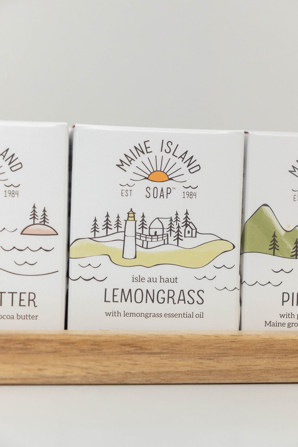 Maine Island Soap Lemongrass bar displayed with other scents on a wooden tray