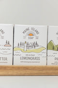 Maine Island Soap Lemongrass bar displayed with other scents on a wooden tray