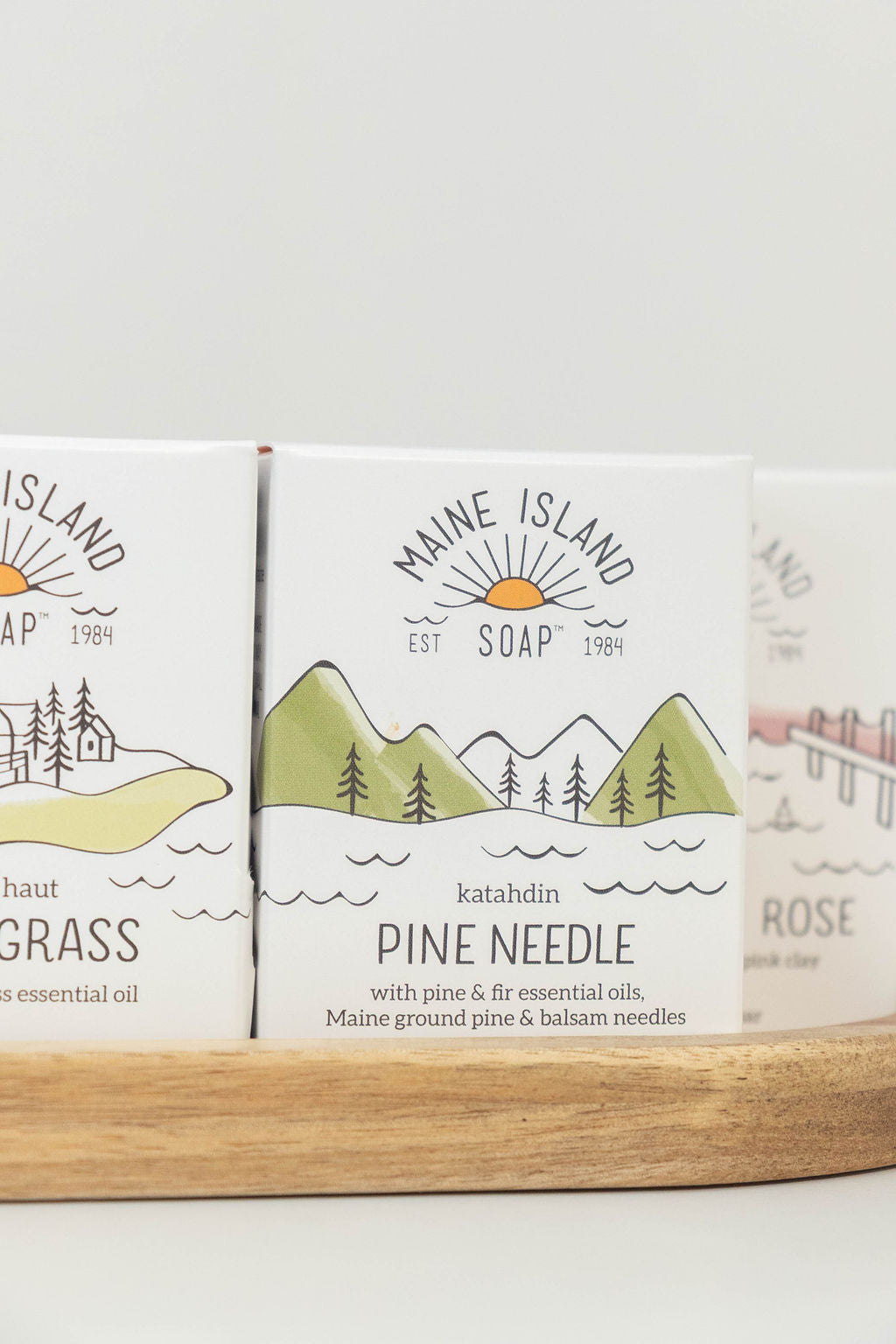 Maine Island Soap Pine Needle bar displayed with other scents on a wooden tray