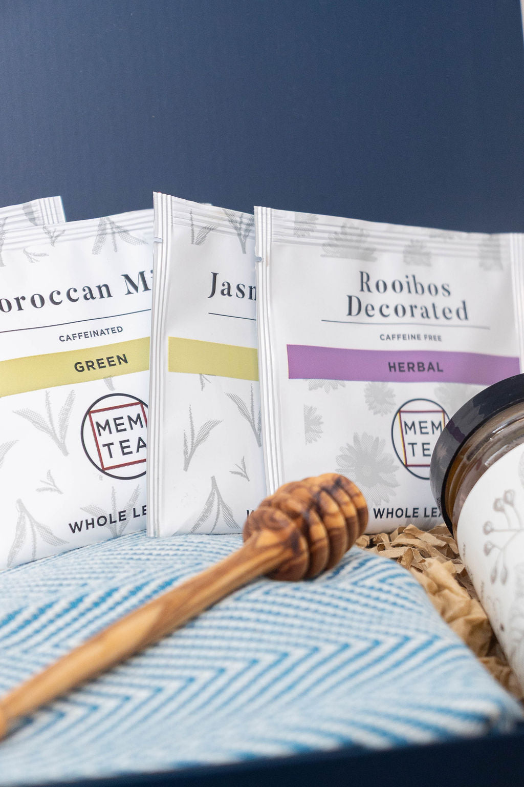 Olive wood honey dipper featured with MEM tea sachets