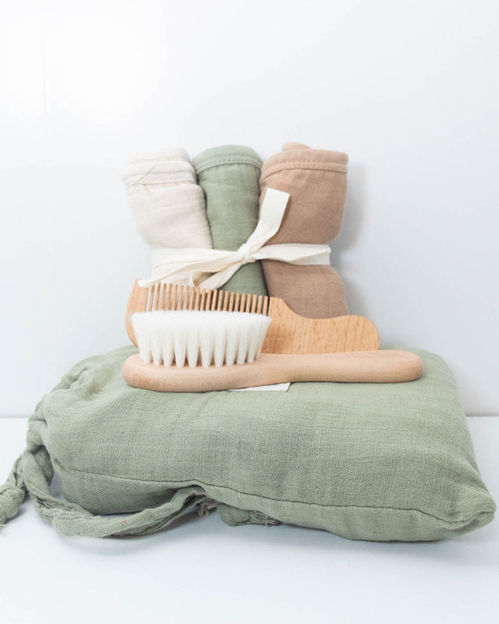 Plum & Sparrow olive hooded towel and washcloths, featured with wooden brush and comb set.