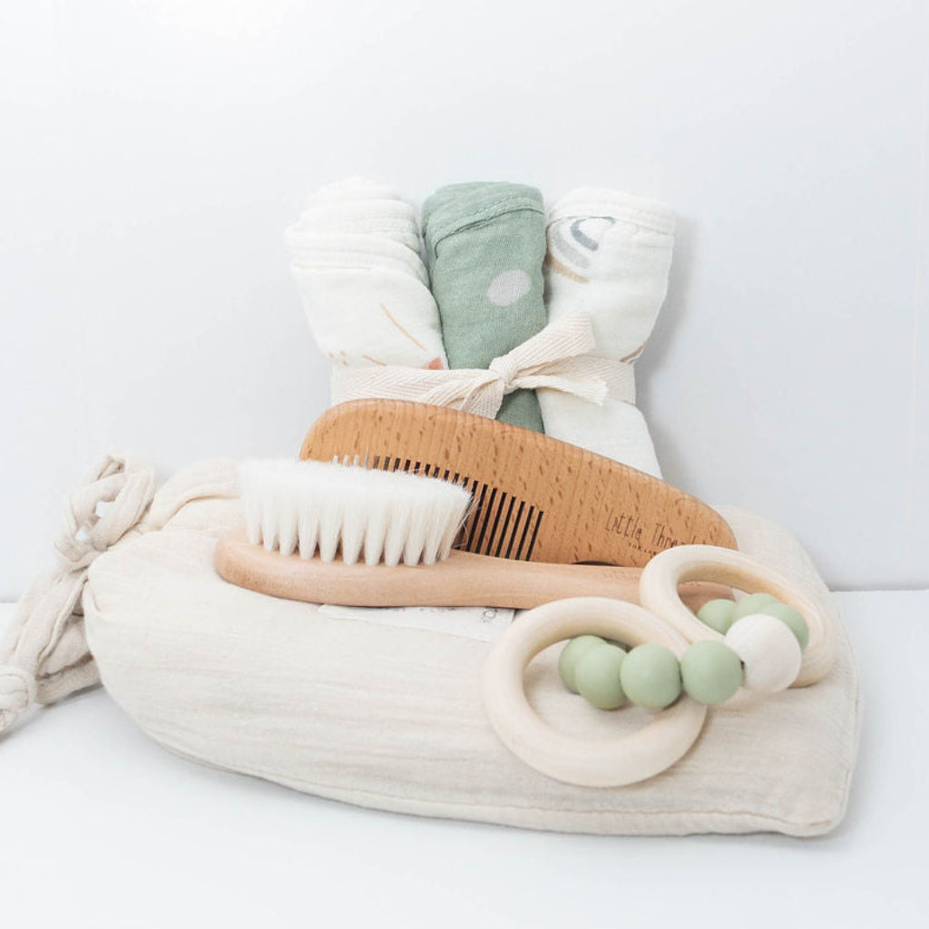 Baby bath gift set with Plum & Sparrow hooded towel washcloths and teether, wooden brush and comb.