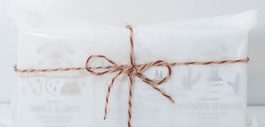 Maine Island Soap trio gift set wrapped in white tissue paper and tied with red and natural baker’s twine.