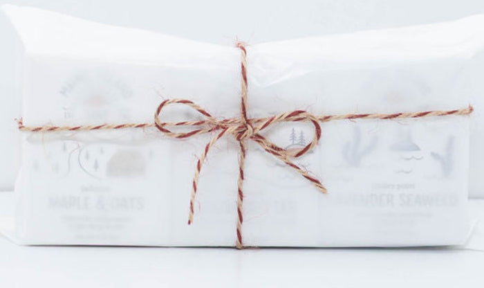Maine Island Soap trio gift set wrapped in white tissue paper and tied with red and natural baker’s twine.