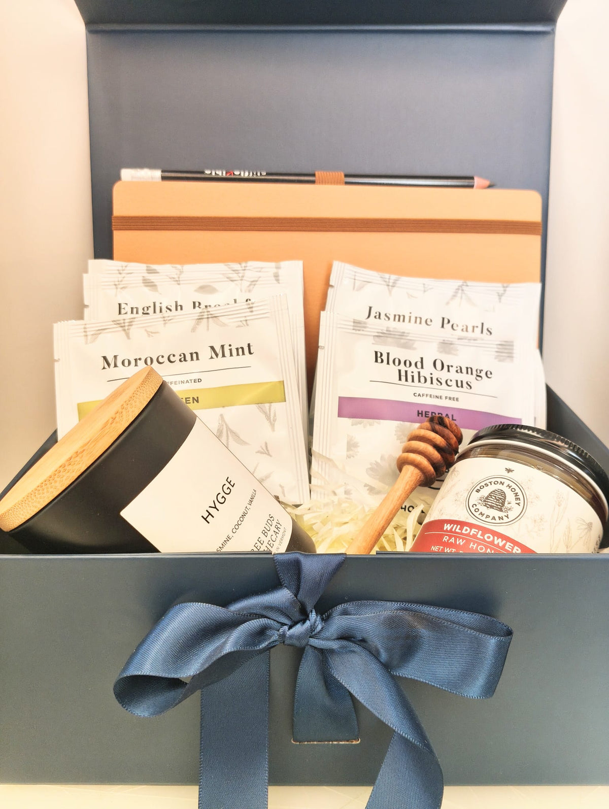 Hygge gift box with candle, light brown Italian notebook, MEM tea, wildflower honey and olive wood honey dipper.