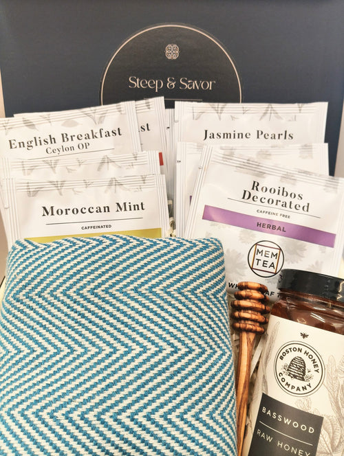 Solefina tea and honey gift box with tea sampler, basswood honey, honey dipper and blue herringbone peshtemal towel.