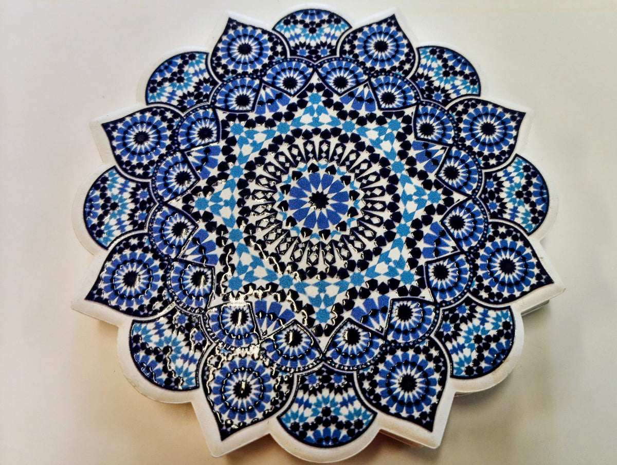 Moroccan-inspired ceramic coaster with a scalloped floral edge and intricate concentric mosaic patterns in navy blue, cobalt blue and white.