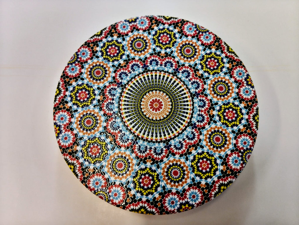 Round Moroccan-inspired ceramic coaster featuring densely arranged floral and geometric mosaic patterns in turquoise, blue, orange, red, yellow and white, surrounding a detailed circular medallion.