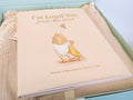 Newborn baby gift set featuring a beige lace-trimmed Petite Evelina muslin blanket and I've Loved You from the Start by Tabitha Paige, arranged in a sage green keepsake gift box.