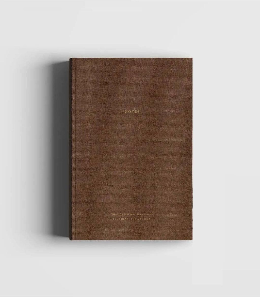 Dark brown linen hardcover notebook with gold foil lettering by Cozy Publishing.