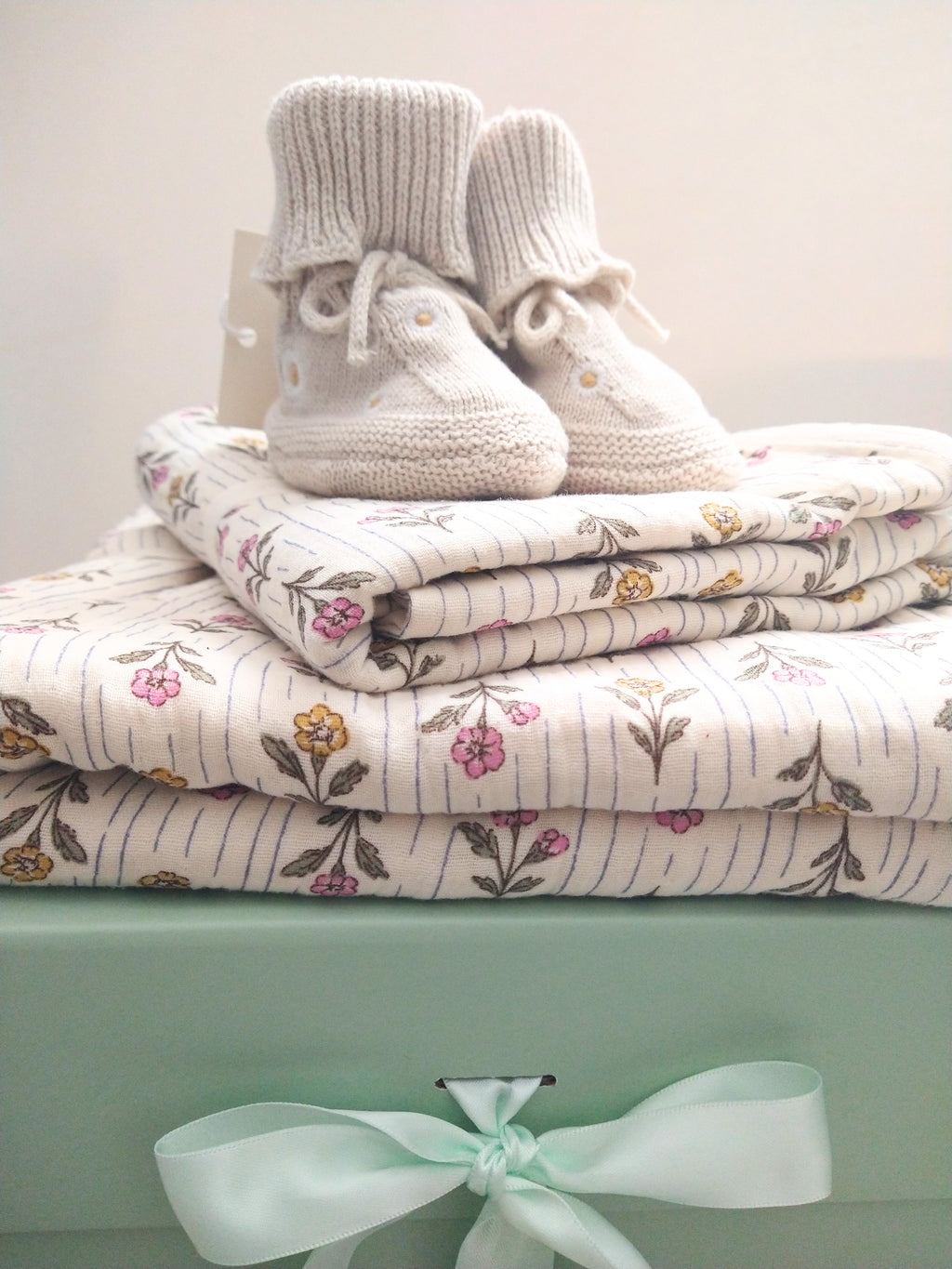Petite Evelina Meadow Whisper baby blanket and swaddle with Saga Copenhagen Daisy booties.