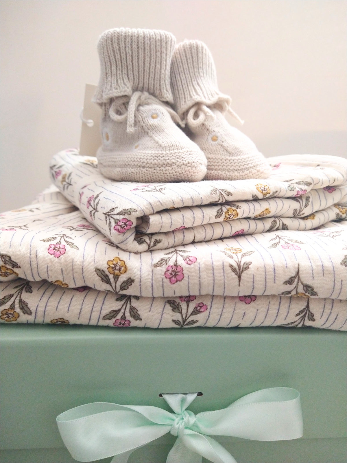 Petite Evelina Meadow Whisper baby blanket and swaddle with Saga Copenhagen Daisy booties.
