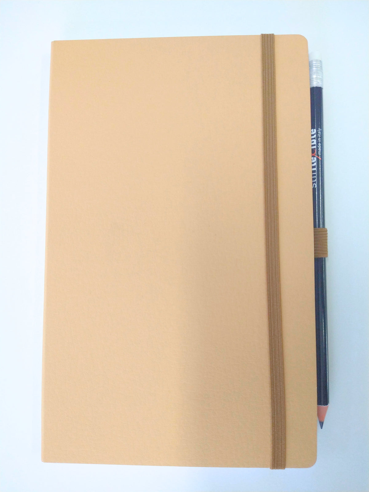 Light brown Stifflexible notebook made in Italy with attached pencil.