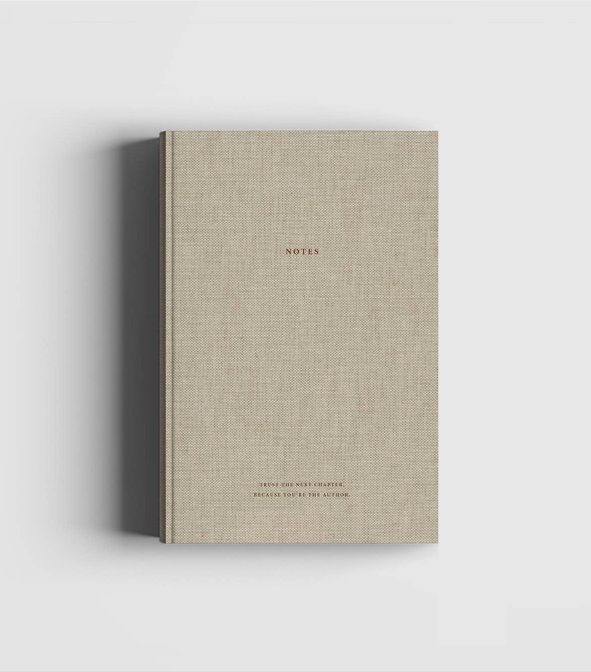 Natural linen hardcover notebook with dark brown foil lettering by Cozy Publishing.